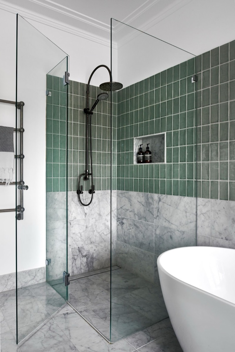 Frameless shower screen with hinge panel, door and return panel in polished chrome hardware, sage green tiles and marble floor